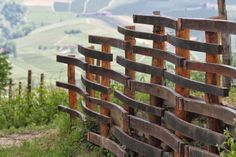 a wooden fence in the middle of a field