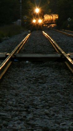 the sun is shining down on railroad tracks