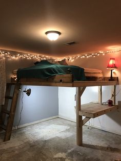 there is a loft bed with lights on the ceiling