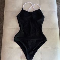 Black With White Straps Super Sexy Cut Has Padding For Additional Support Quick Dry Material Can Be Worn As Swimsuit Or Bodysuit Size S Black One-piece Leotard For Pool, Summer Black Backless Leotard, Black Backless Leotard For Summer, Black One-piece Leotard For Poolside, Backless Black Leotard For Summer, Black Backless Summer Leotard, Black Beach Leotard With Lined Body, Beach Black Leotard With Lined Body, Black Beachwear Leotard For The Beach