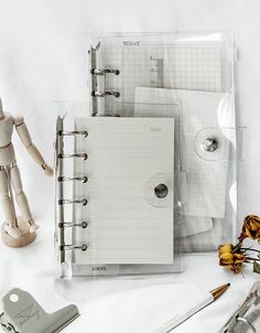 three notebooks and tools on a white surface