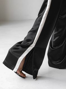 Midweight satin track trouser pants with side stripe in contract color. Straight leg with slight flare at bottom. Model is in MINUSEY S.* MINUSEY S = EU 34, US 2* MINUSEY M = EU 36, US 4* 100% Polyester* Dry clean* Made in Korea - Model Height: 172cm/5'7" (US2, EU34) Black Satin Wide-leg Pants, Black Full-length Satin Pants, Black Full Length Satin Pants, Black Satin Full-length Pants, Pants With Side Stripe, Stripe Outfits, Side Stripe, The Trend, Trouser Pants