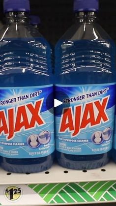 three bottles of ajax are on display in a grocery store for $ 1 99 each