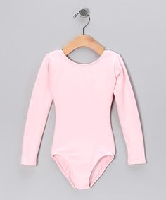 a pink bodysuit hanging on a wooden hanger