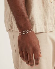 A Vibe signature, this slimmest version of the St. John Hook Bracelet is fashioned in gently hammered sterling silver with a "J" hook clasp to honor the island of St. John. Featuring a tiny replica of the St. John petroglyph and seven good luck wraps, solo or stacked, it is sure to be a favorite piece. Found in many of our designs, Vibe’s seven good luck wraps represent love, laughter, happiness, good fortune, health, unity, and peace. In the Caribbean tradition, wear your hook facing in to keep Adjustable Sterling Silver Bracelet With Polished Finish For Everyday, Adjustable Hammered Sterling Silver Minimalist Bracelet, Minimalist Adjustable Sterling Silver Bracelet With Lobster Clasp, Hook Bracelet, Hammered Sterling Silver, Hook Clasp, A J, Sterling Silver Bands, Handmade Design