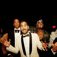 a group of men in tuxedos standing next to each other at a party