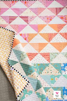 two quilts are laying on top of each other, one is pink and the other is orange