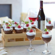 there are many desserts in glasses on the table