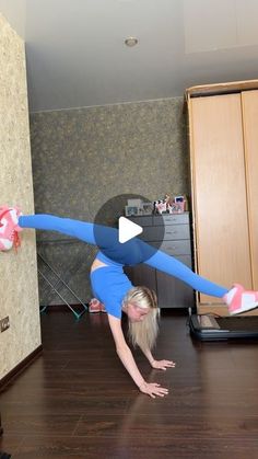 a woman is doing a handstand on the floor