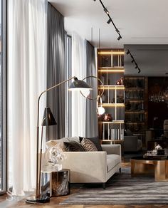 a living room with a couch, chair and book shelf