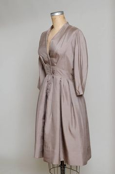 "1950s Modern Silk Camel Brown Anjac Fashions California Button Down Shirt Dress Camel brown silk, this dress has a beautiful modern cut. Gathered waistline, with a batwing cut. Anjac of California. Measurements shoulders: free chest: 39\" waist: 27\" length: 42.5\"" Elegant V-neck Vintage Dress For Daywear, Elegant A-line Vintage Dress For Daywear, Elegant Vintage Dress With V-neck For Daywear, Elegant Vintage V-neck Dress For Daywear, Silk Button-up Evening Dress, Button-up Silk Evening Dress, Formal Silk Button-up Dress, Formal Button-up Silk Dress, Elegant A-line Vintage Dress With Buttons