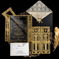 black and gold wedding stationery with an ornate gate, lettered monogrammed pocketfold