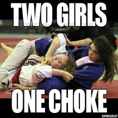 two girls are wrestling and one is on the ground with their arms around each other