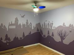 an empty room with a painted mural on the wall