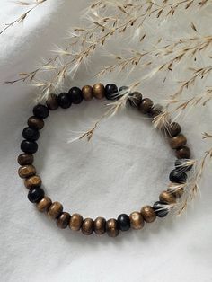 This elastic bracelet is made from smaller raw wooden beads. Earthy Brown Bracelets With Wooden Beads, Brown Wood Beaded Bracelets, Casual Brown Wooden Bead Bracelets, Brown Beaded Wood Bracelets, Nature-inspired Brown Beaded Bracelets With Wooden Beads, Wooden Beaded Bracelets, Clay Bead, Bead Ideas, Elastic Bracelet