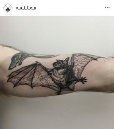 a man with a bat tattoo on his arm