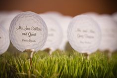 four golf balls are placed on top of each other in front of some green grass