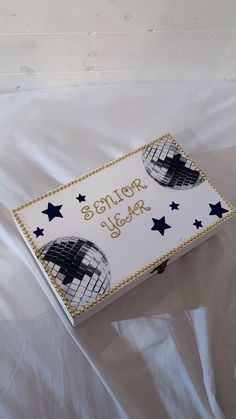 a white box with blue stars and the words sisters rock written in gold on it