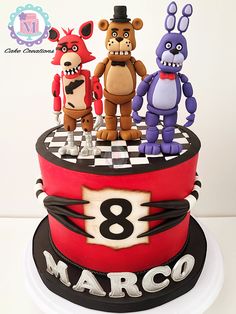 three cartoon characters are on top of a red and black cake that says 8 marco