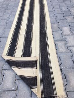 a black and white striped rug laying on the ground