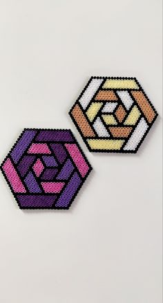 two different colored geometric designs on a white surface