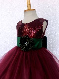 Have your little girl sparkle along with the Christmas lights with this gorgeous dress! The sleeveless dress comes with a fully lined sequence top. A zipper can be found going down the back of the dress. The dress is followed by a double layer of tulle that is lined with fishing line to give the bottom of it's skirt it's wavy texture. Underneath both layers of tulle are two layers of lining, one plain and a final layer of lining with crinoline attached for fullness. Finish the dress off with a d Tulle Christmas Dress For Dress-up Occasions, Tulle Christmas Dress-up Holiday Dress, Tulle Christmas Holiday Dress For Dress-up, Tulle Christmas Holiday Dress-up Dress, Holiday Tulle Princess Dress, Holiday Princess Dress In Tulle, Princess Style Tulle Holiday Dress, Holiday Tulle Dress, Princess Style Tulle Gown For Christmas