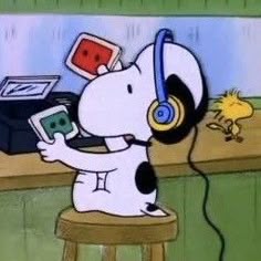 a cartoon dog with headphones on sitting at a desk