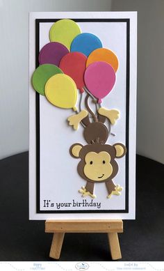 a birthday card with a monkey holding balloons