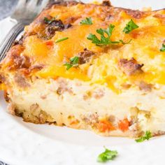 a white plate topped with a cheesy casserole