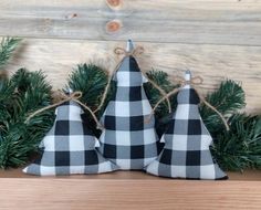 two black and white christmas trees are sitting on a shelf