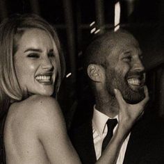 a man and woman laughing together at an event