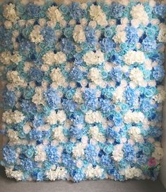 a blue and white crocheted wall hanging in a room with carpeting on the floor