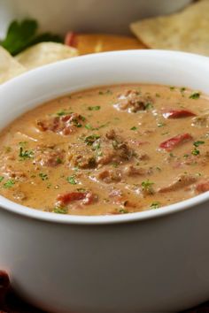 a white bowl filled with soup next to tortilla chips