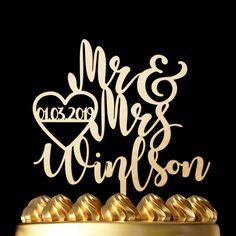 a wedding cake topper with the word mr and mrs written on it in white