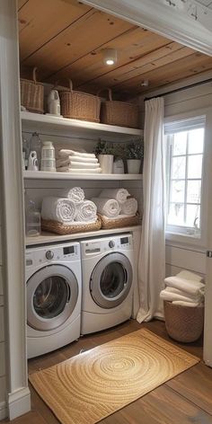 a washer and dryer in a small room with open shelving above it