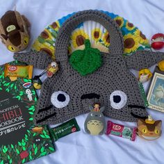 the contents of a crocheted animal purse laid out on top of a bed