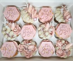 cupcakes decorated with pink icing in a box