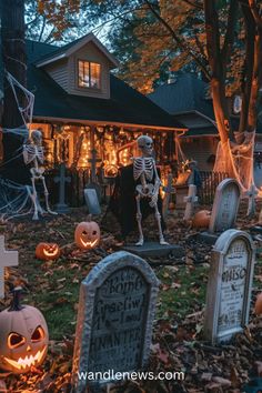 halloween decorations in front of a house with pumpkins and jack - o'- lanterns