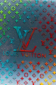 the louis vuitton logo is surrounded by multicolored stars and sparkles