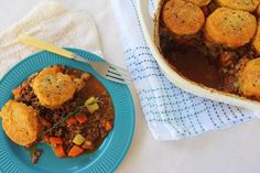 a blue plate topped with food next to a casserole dish