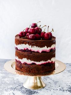 a chocolate cake with cherries on top