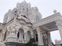 an ornate white building with many windows and balconies