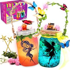 two mason jars with fairy images on them, one is blue and the other is pink