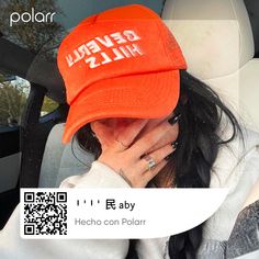 a woman wearing an orange hat with the words beverly hills printed on it in chinese