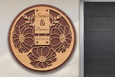 a wooden sign with flowers on it next to a door