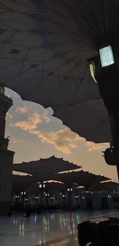 many umbrellas are hanging in the air at dusk