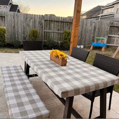 a picnic table and bench with flowers on it