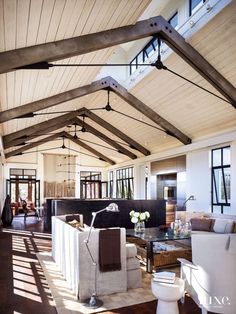 a living room filled with furniture and windows