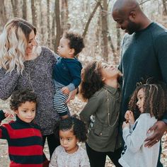 a family standing together in the woods