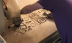 a man is working on some type of metal object with the word cut out in it